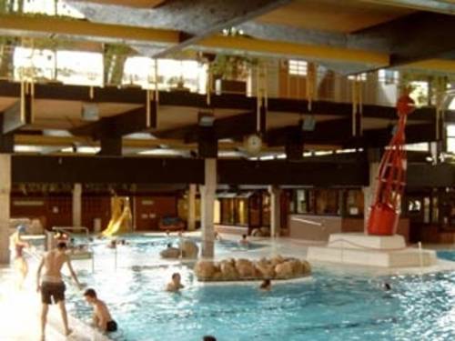 Schwimmer im Becken und am Beckenrand im Vahrenwalder Bad