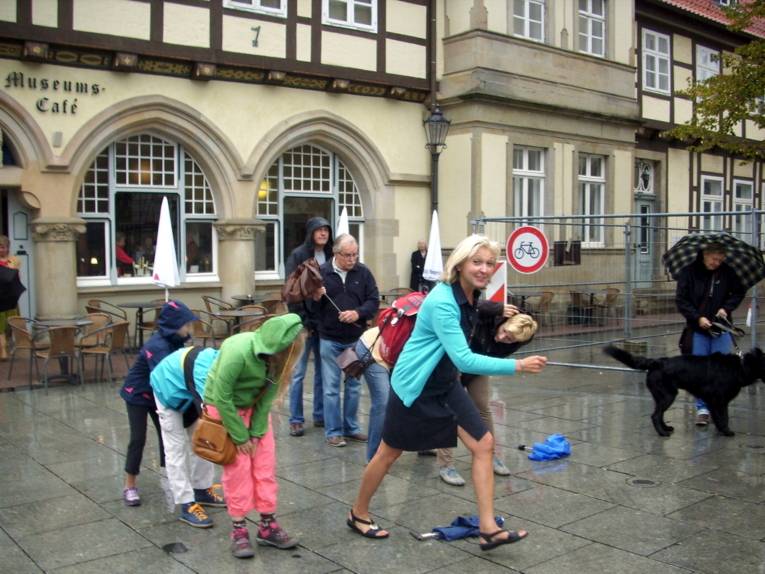 Eine Stadtführerin animiert Kinder zu einem Spiel in der Celler Altstadt.